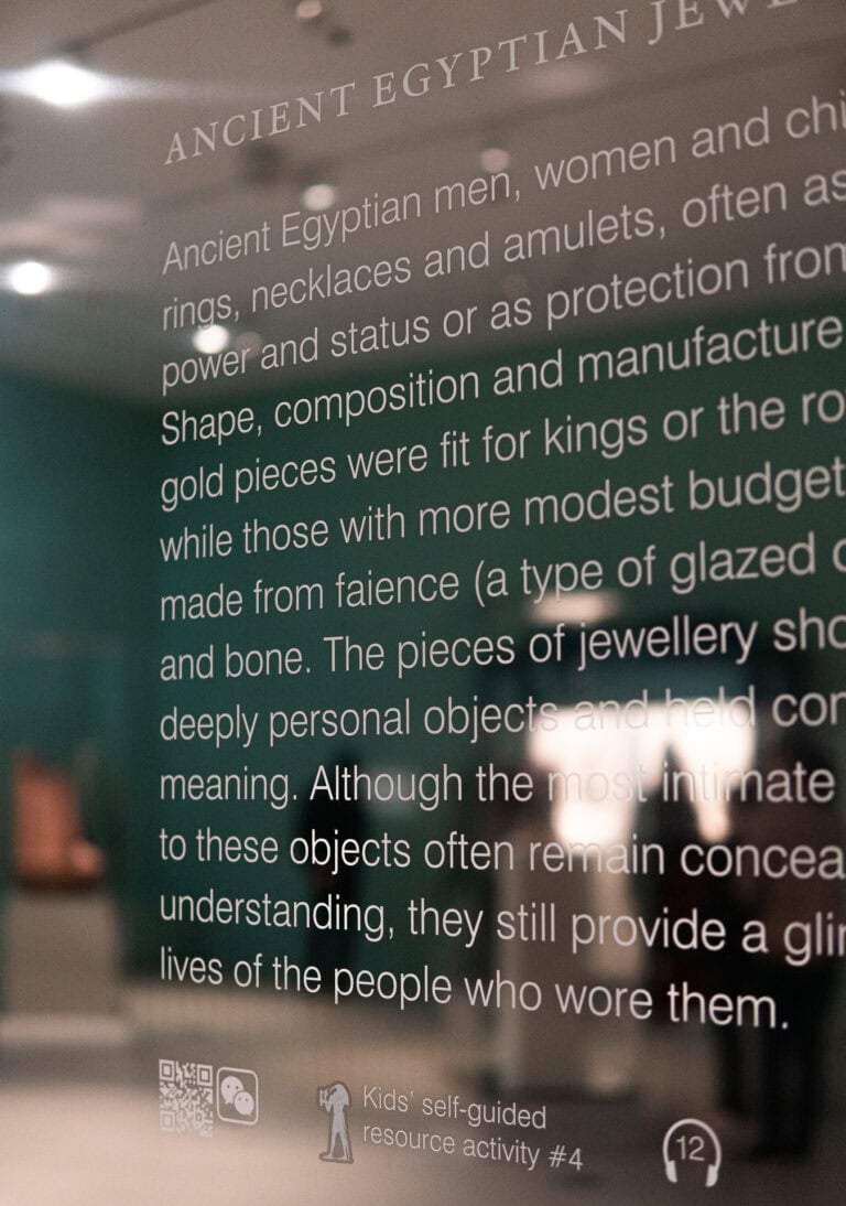 NGV's Pharaoh Exhibition depicting ancient relics from egypt. This photo shows a patron observing the didactic on the wall.